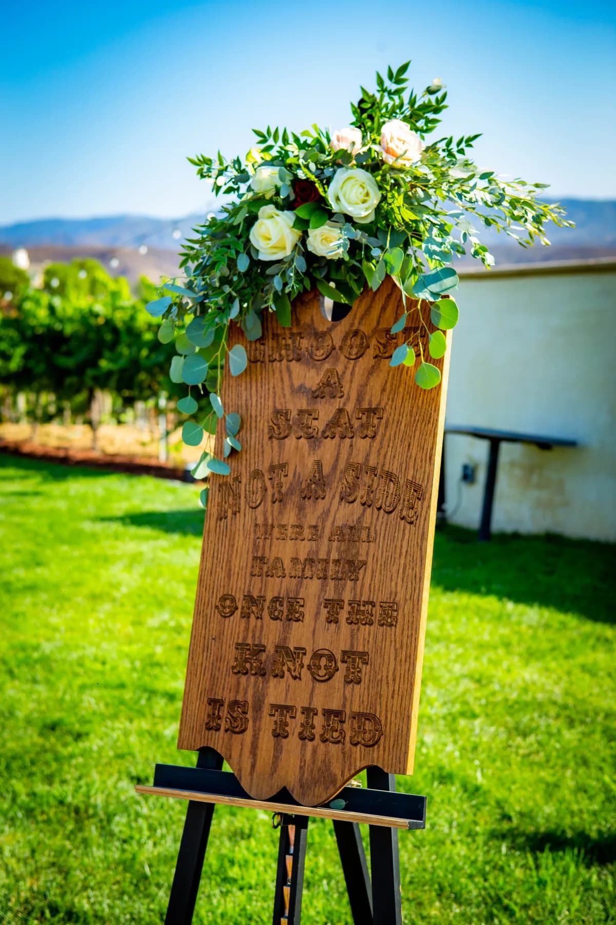 Wedding ceremony sign displayed beside the Leoness Cellars vineyard