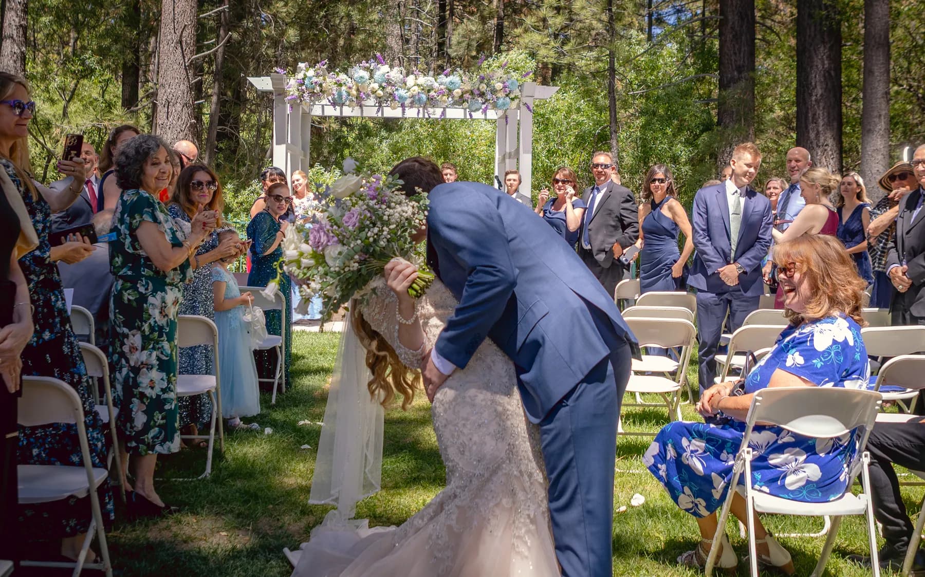 Gloria and Ryan embracing in the aisle as guests watch