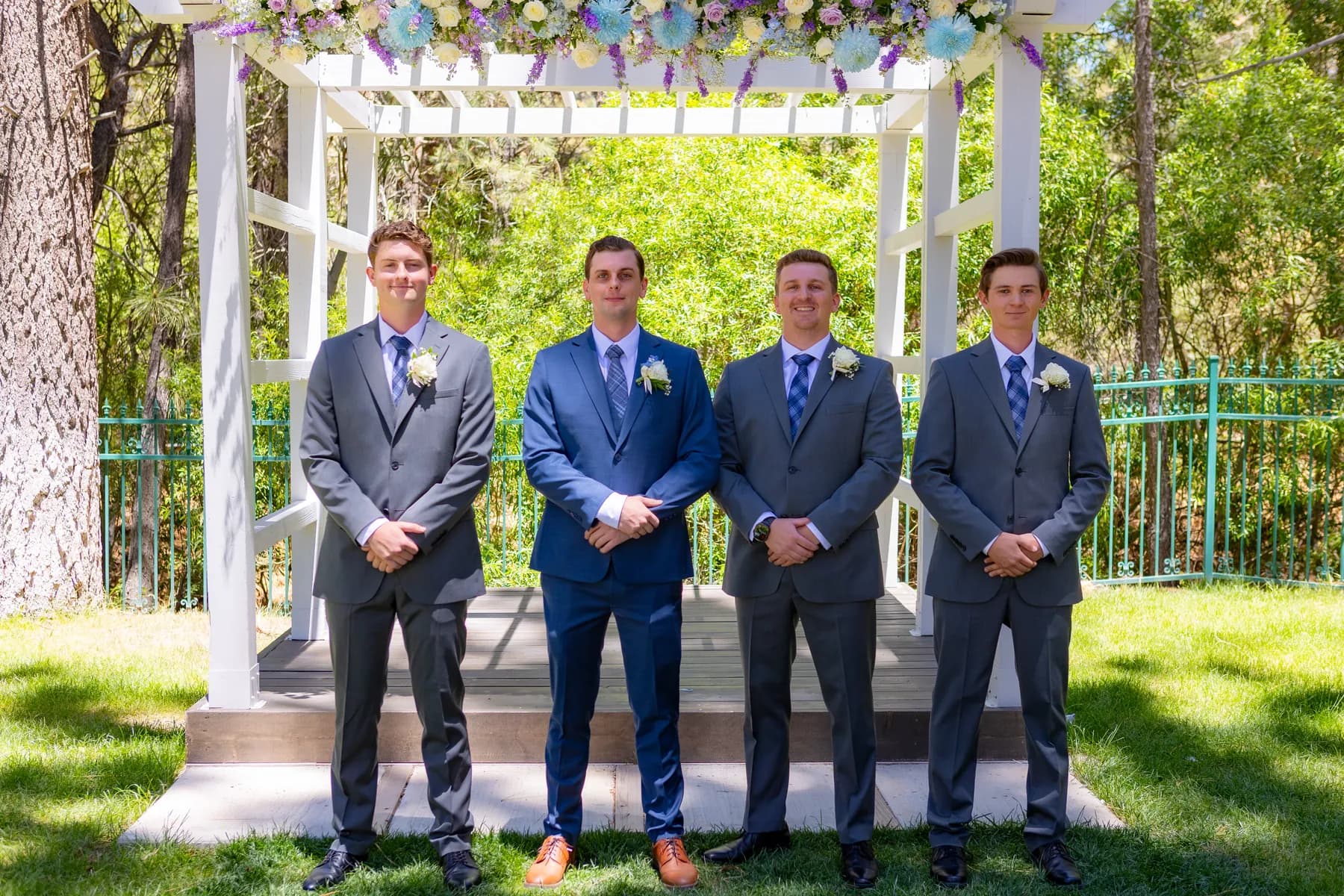 Ryan with three companions beneath the flower-covered outdoor arbor