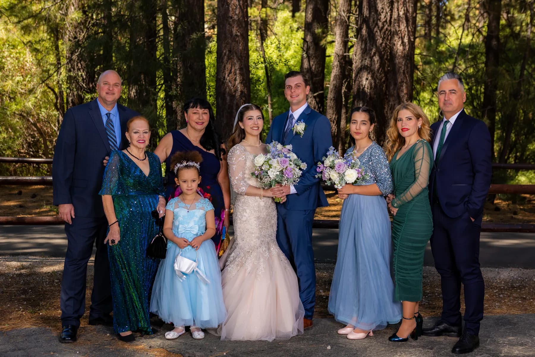 Gloria and Ryan posing with companions in a wooded setting