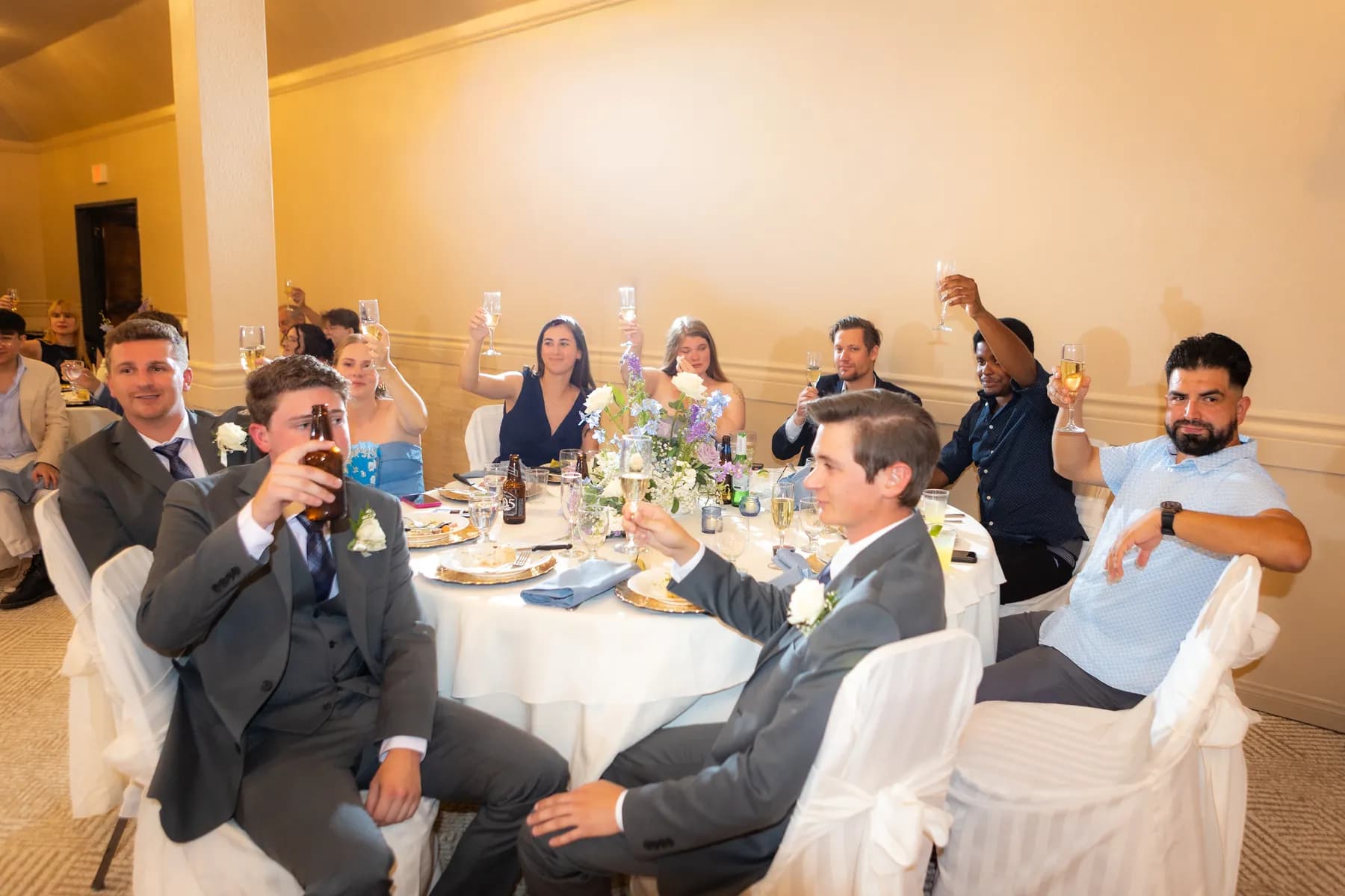Guests raising glasses around a reception table