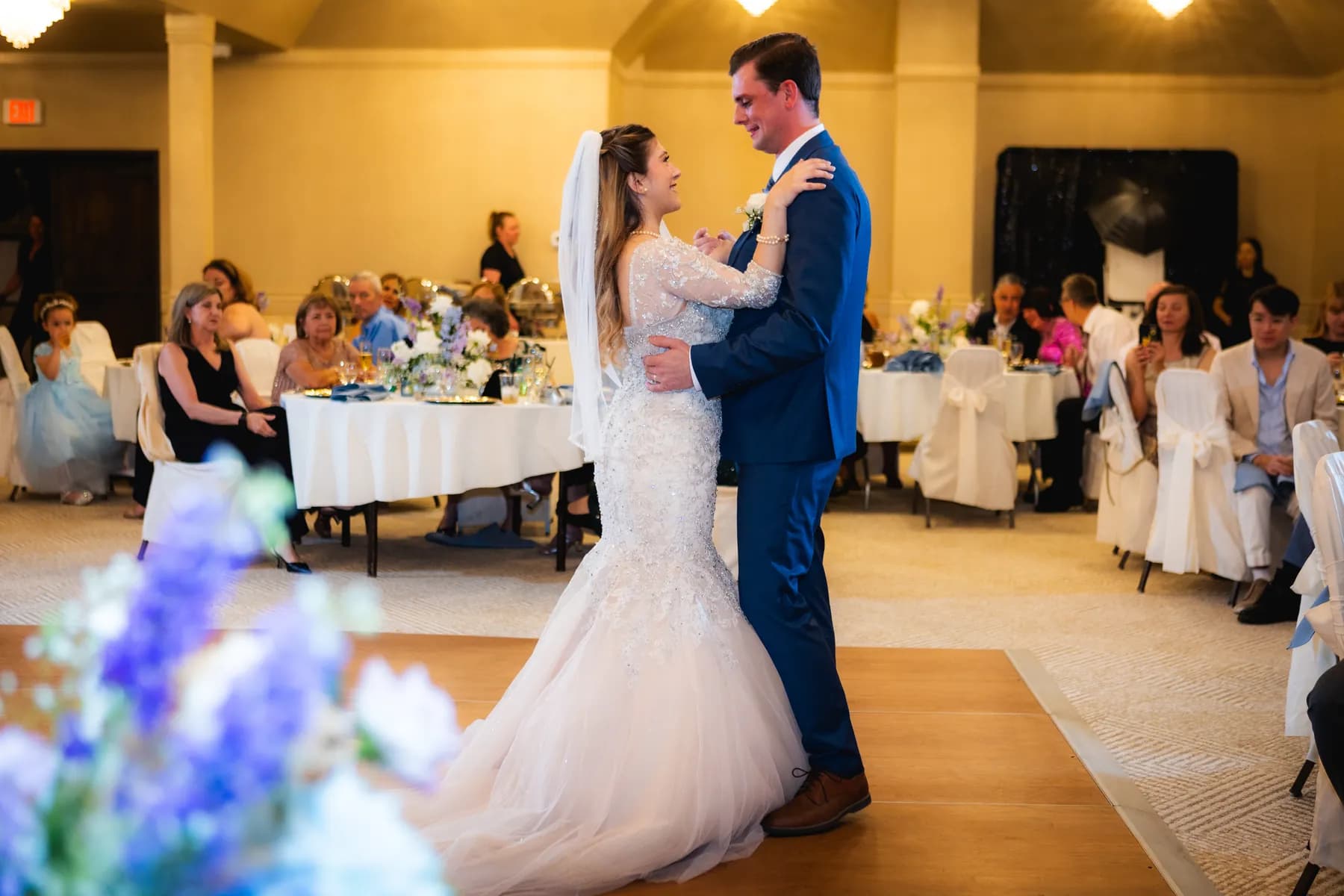 Gloria and Ryan dancing on the reception floor among guests