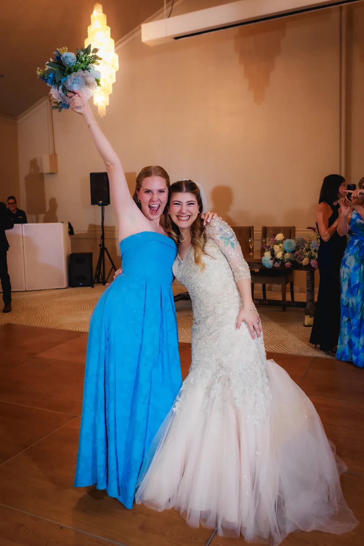 Gloria with a guest in a blue dress on the reception dance floor