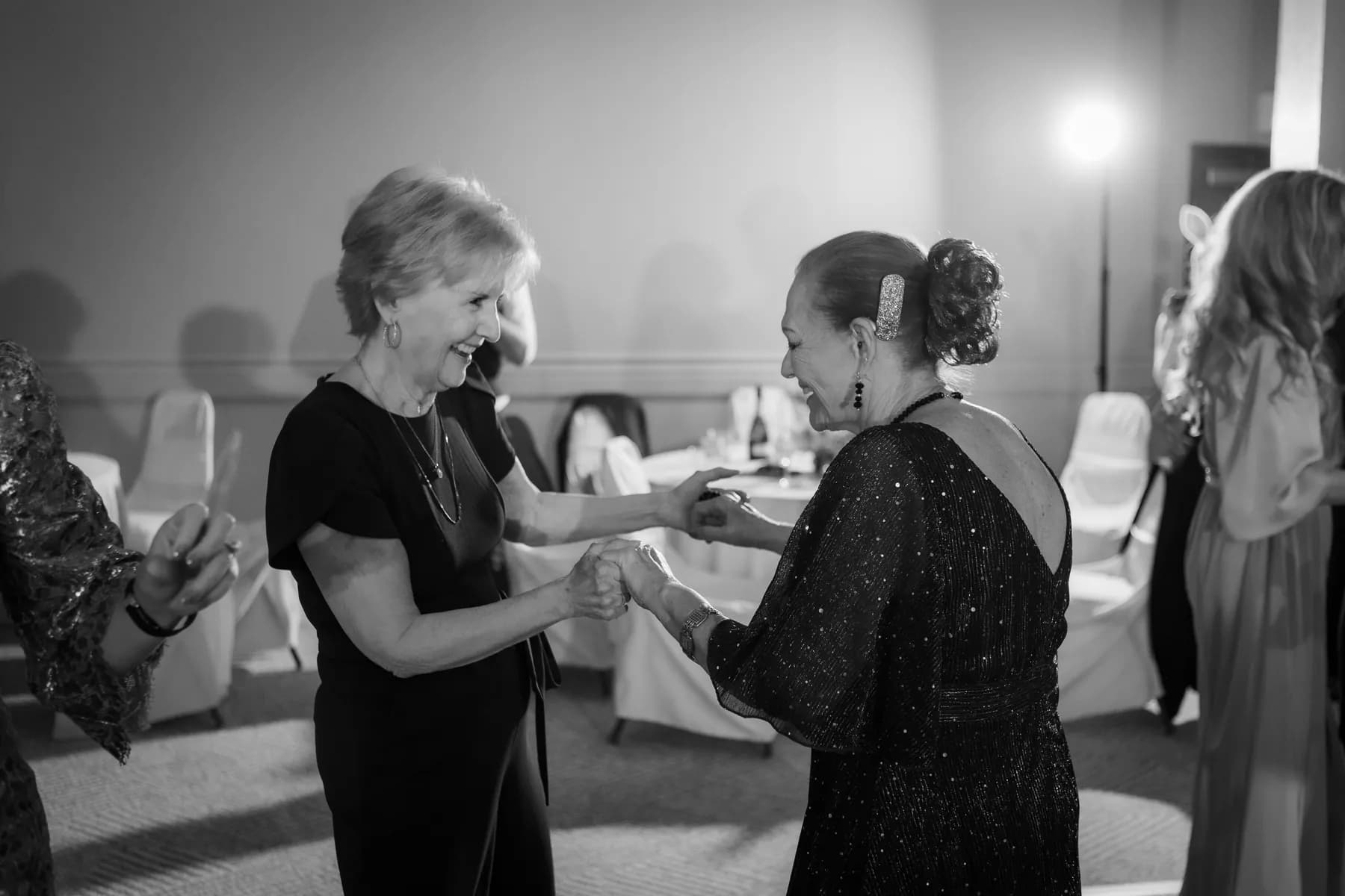 Black-and-white frame of two guests dancing