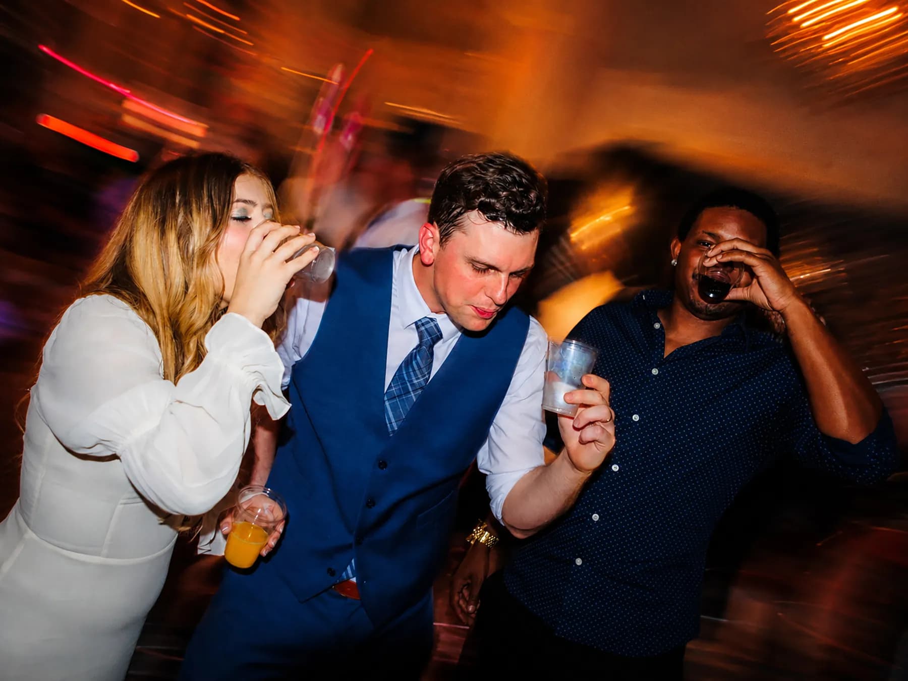 Guests dancing with warm light and motion blur
