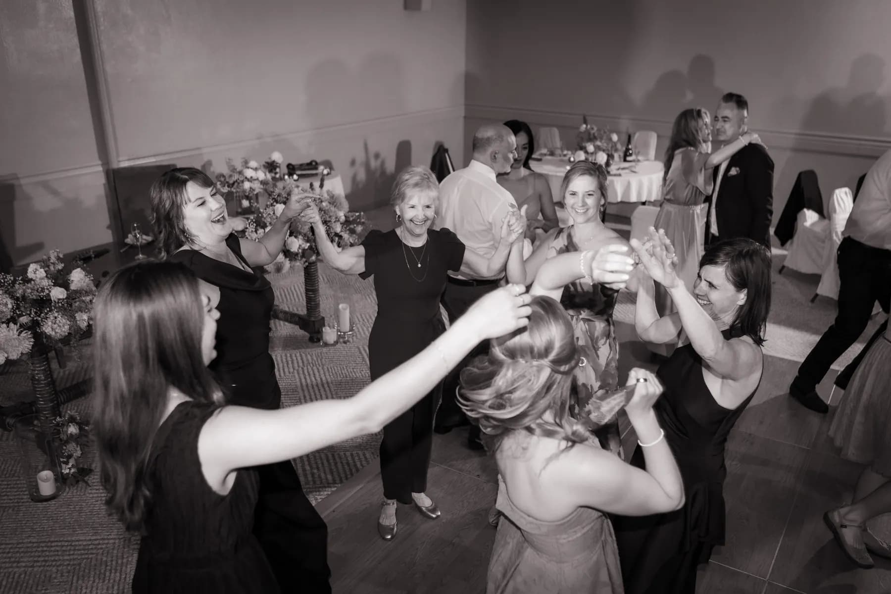 Black-and-white view of guests dancing at the reception