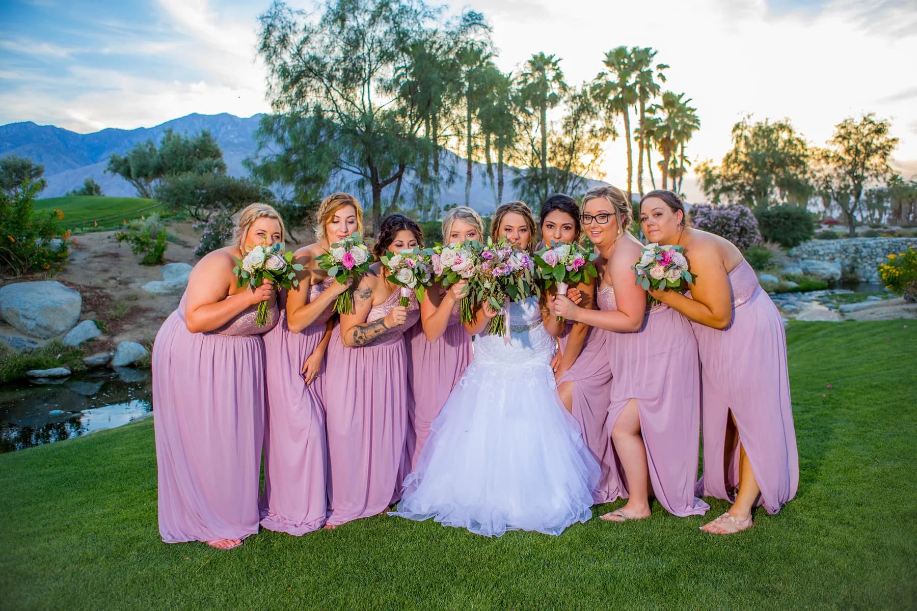 Heather surrounded by bridesmaids in pink dresses