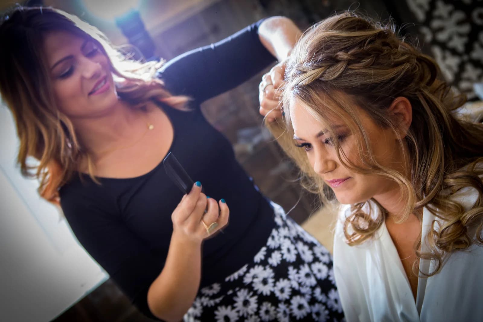 Heather having her makeup finished beside a window