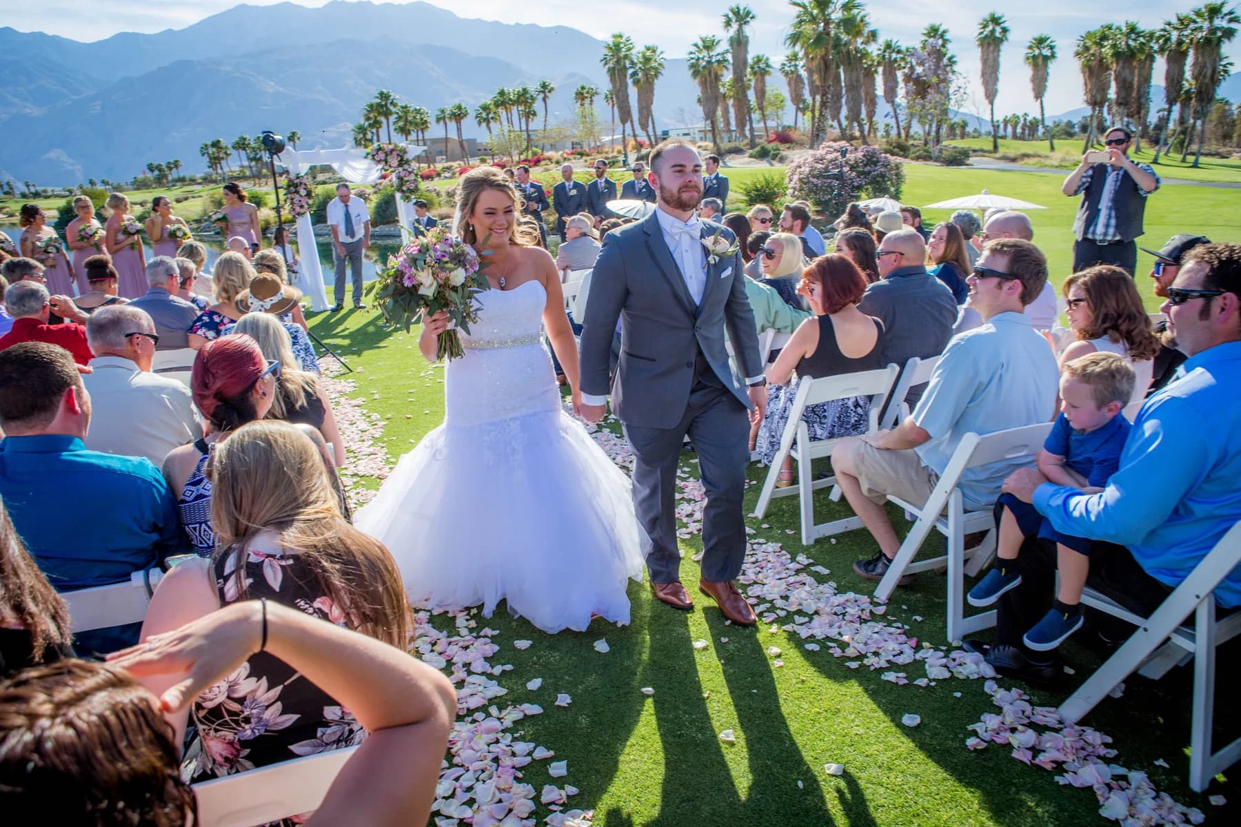 Stephen and Heather walking back up the outdoor ceremony aisle