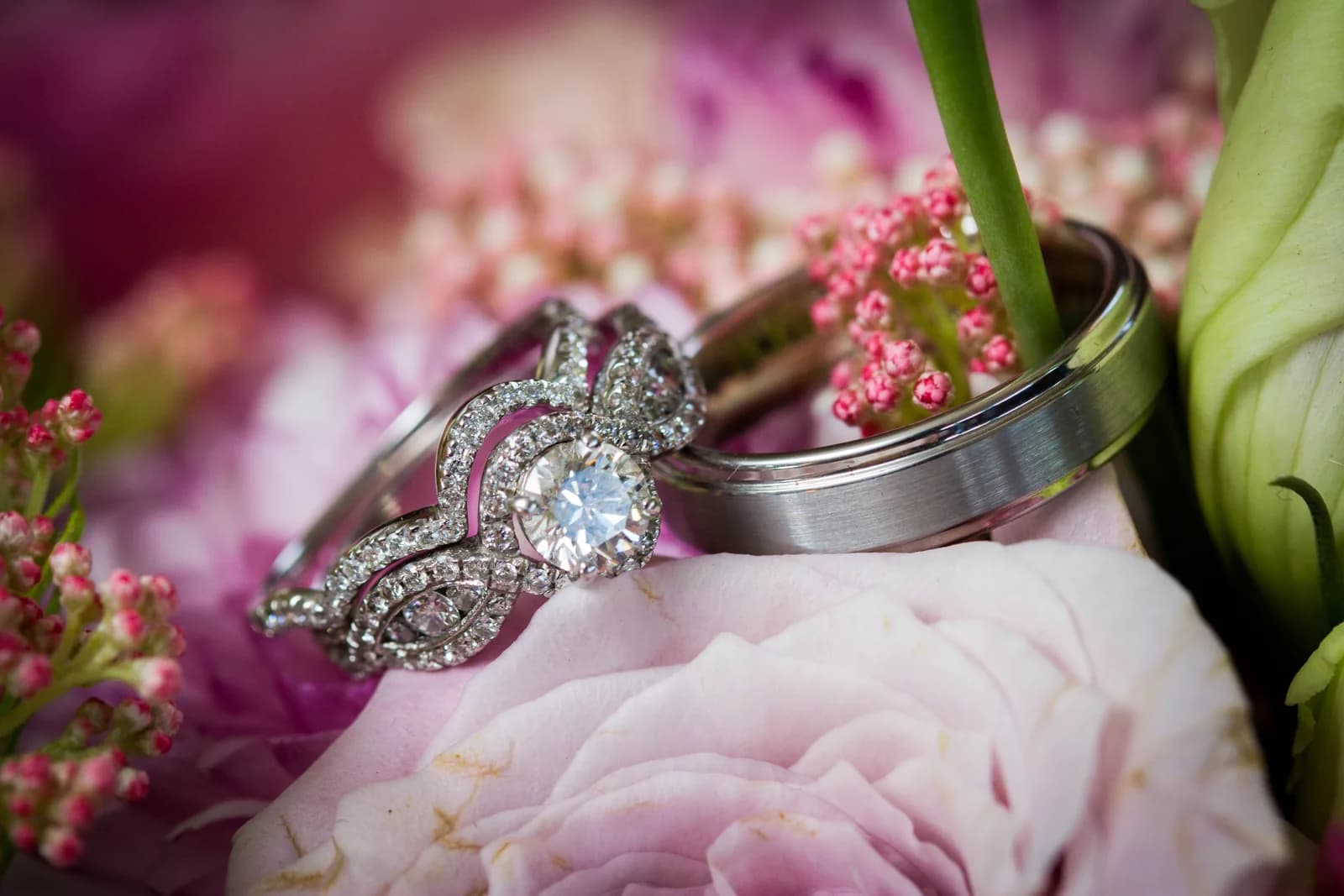 Wedding rings arranged on pink flowers
