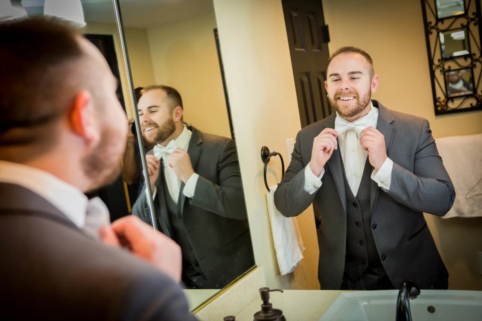 Stephen adjusting his tie while getting ready for the wedding
