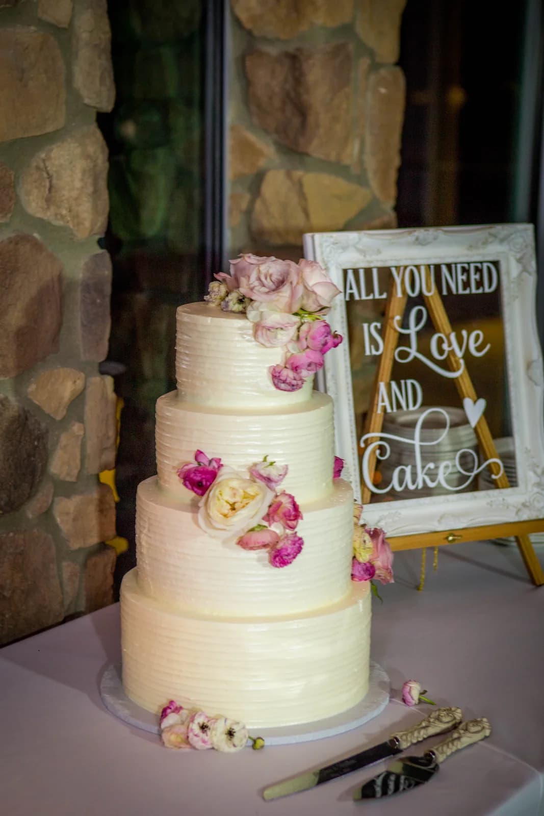 Three-tier wedding cake decorated with pink flowers