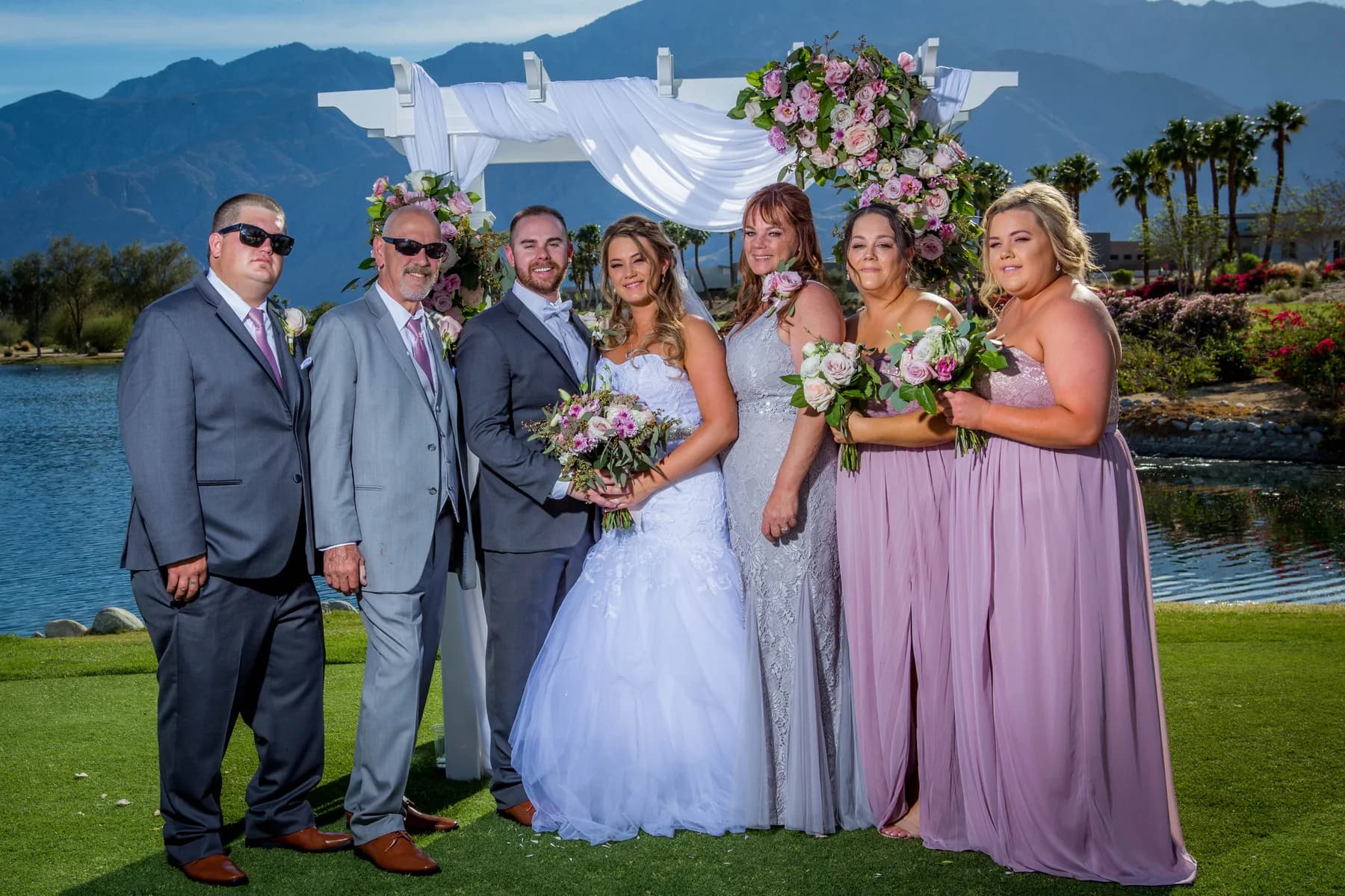 Stephen and Heather with their wedding party beside the water