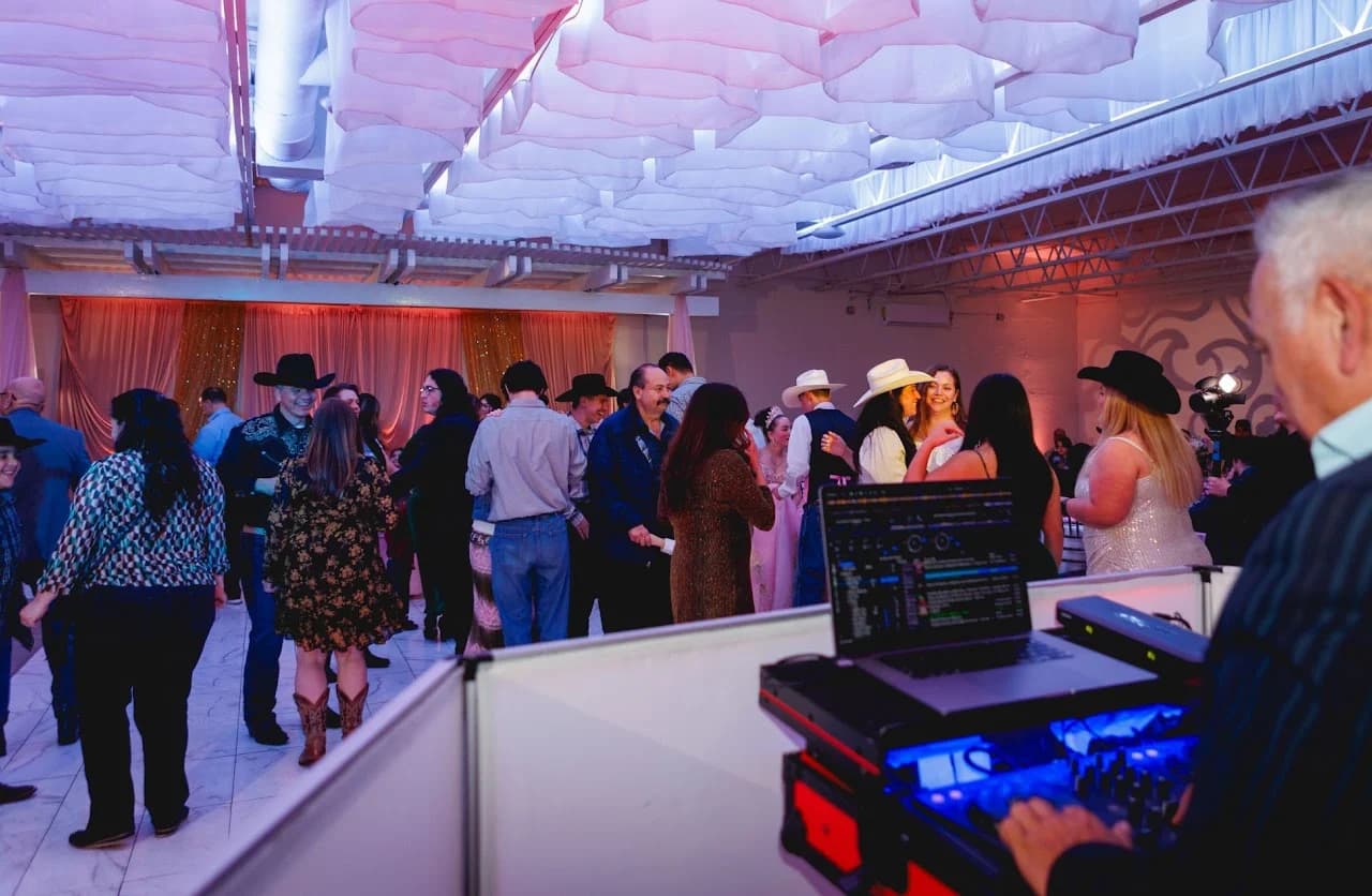 Guests gathered near the DJ equipment and dance floor