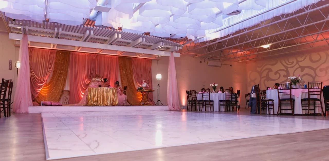 Wide view of the open reception floor and draped backdrop