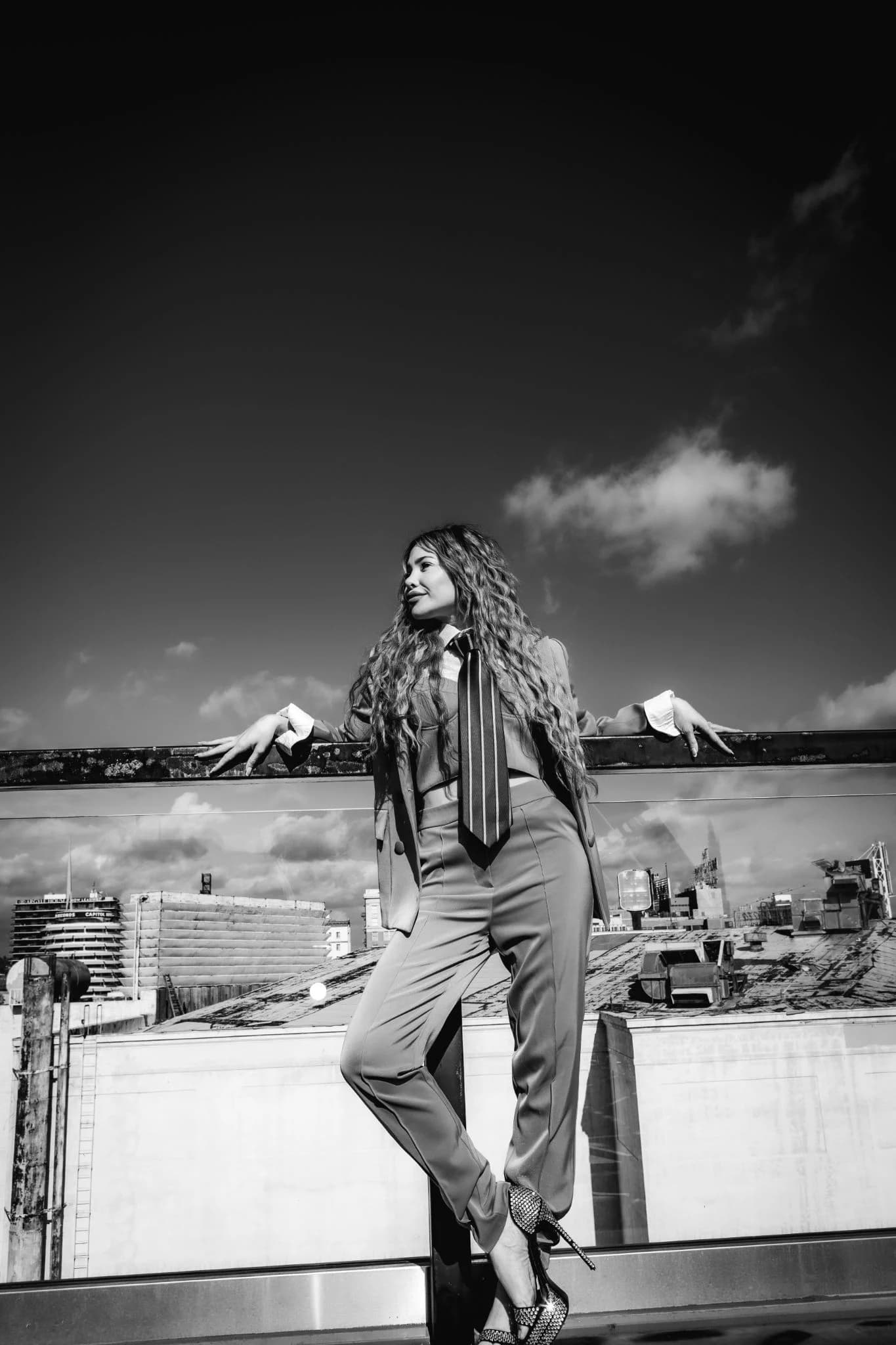 Black-and-white rooftop portrait in a tailored suit