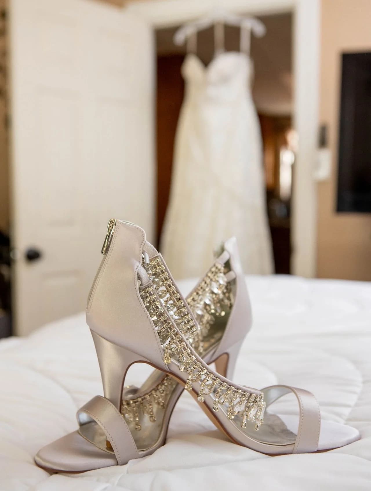 Beaded shoes with a wedding dress in the background