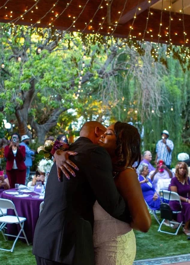 Couple embracing beneath the reception canopy