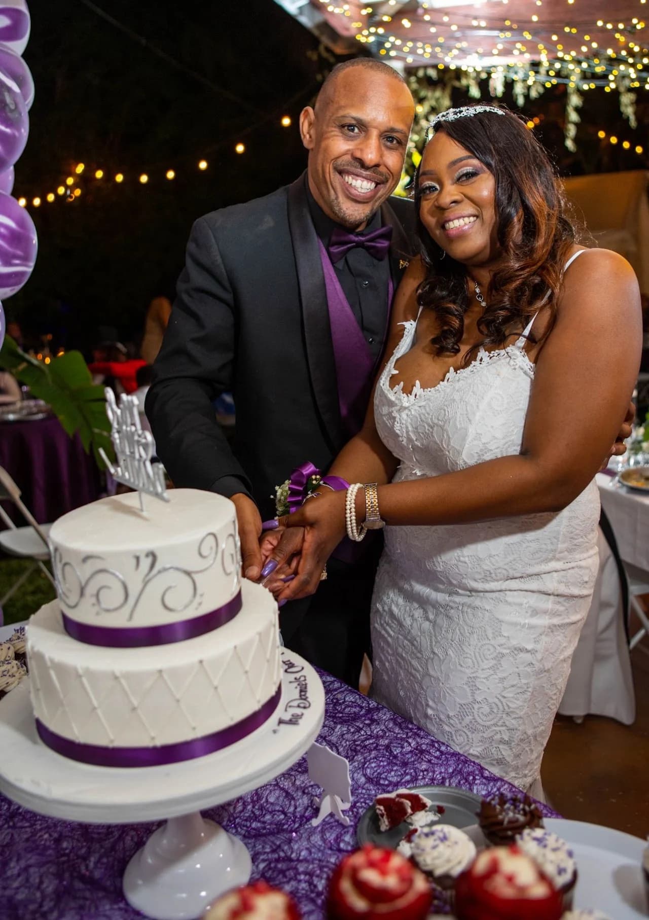 Couple beside their tiered cake