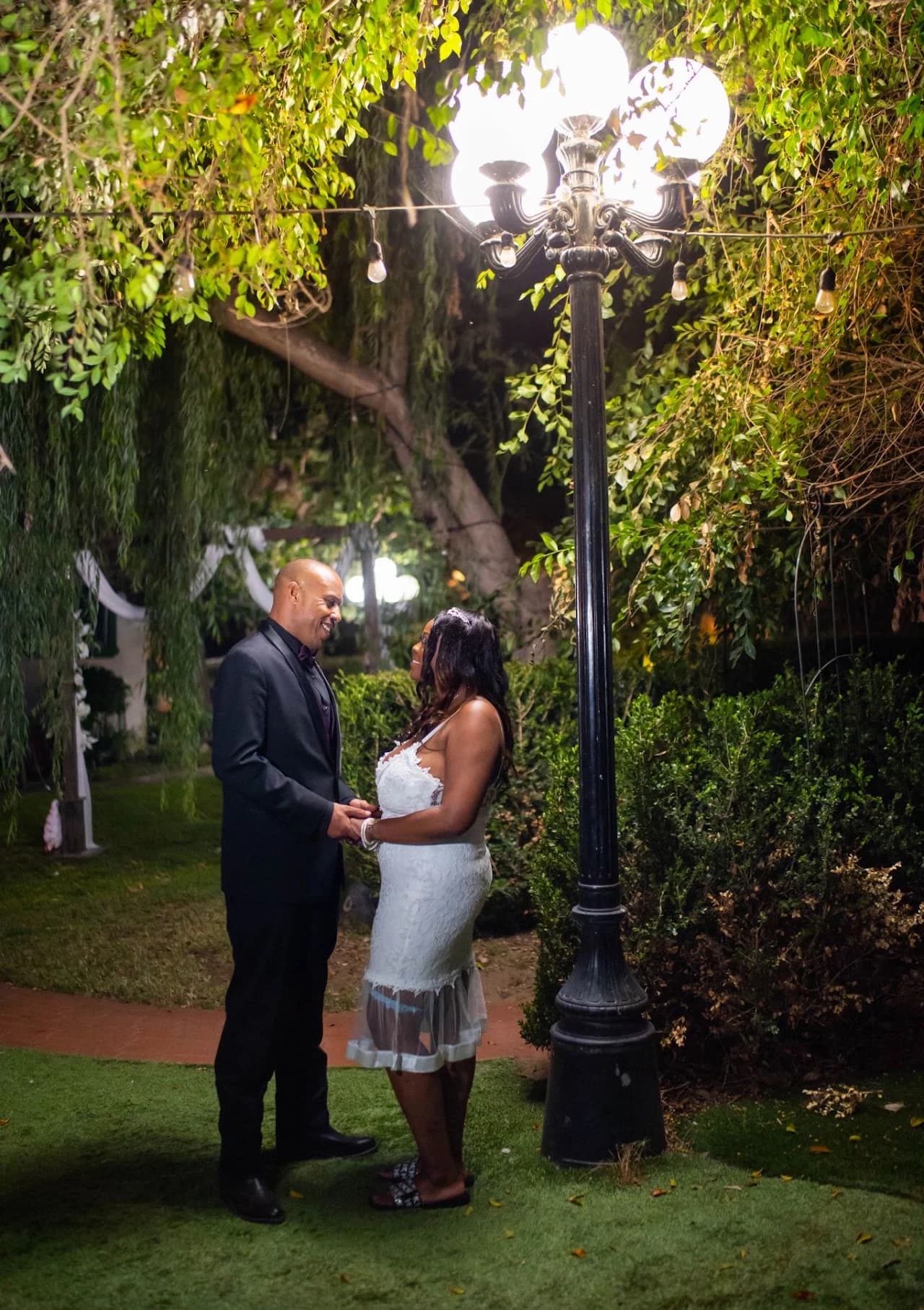 Couple beneath an illuminated garden lamp