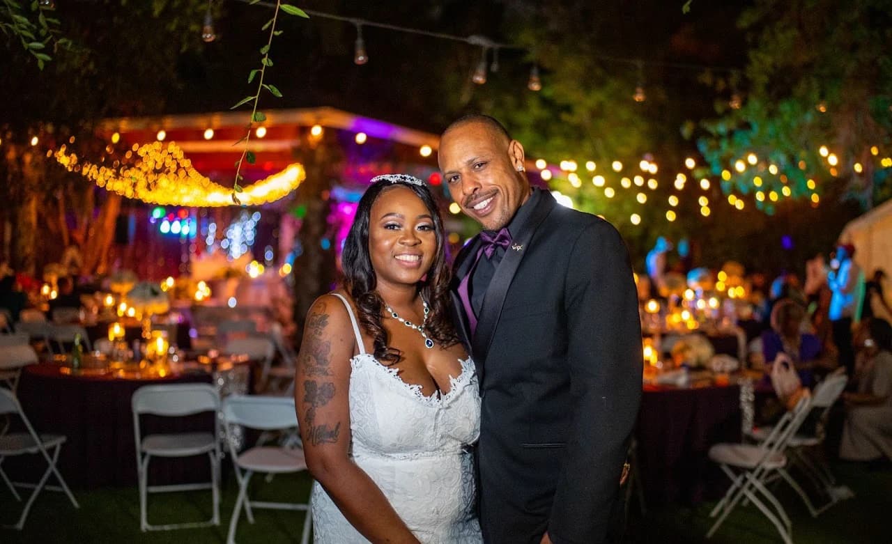 Evening couple portrait with the reception glowing behind them