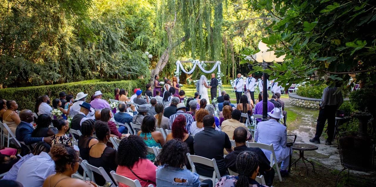 Seated guests facing the white-draped ceremony arbor