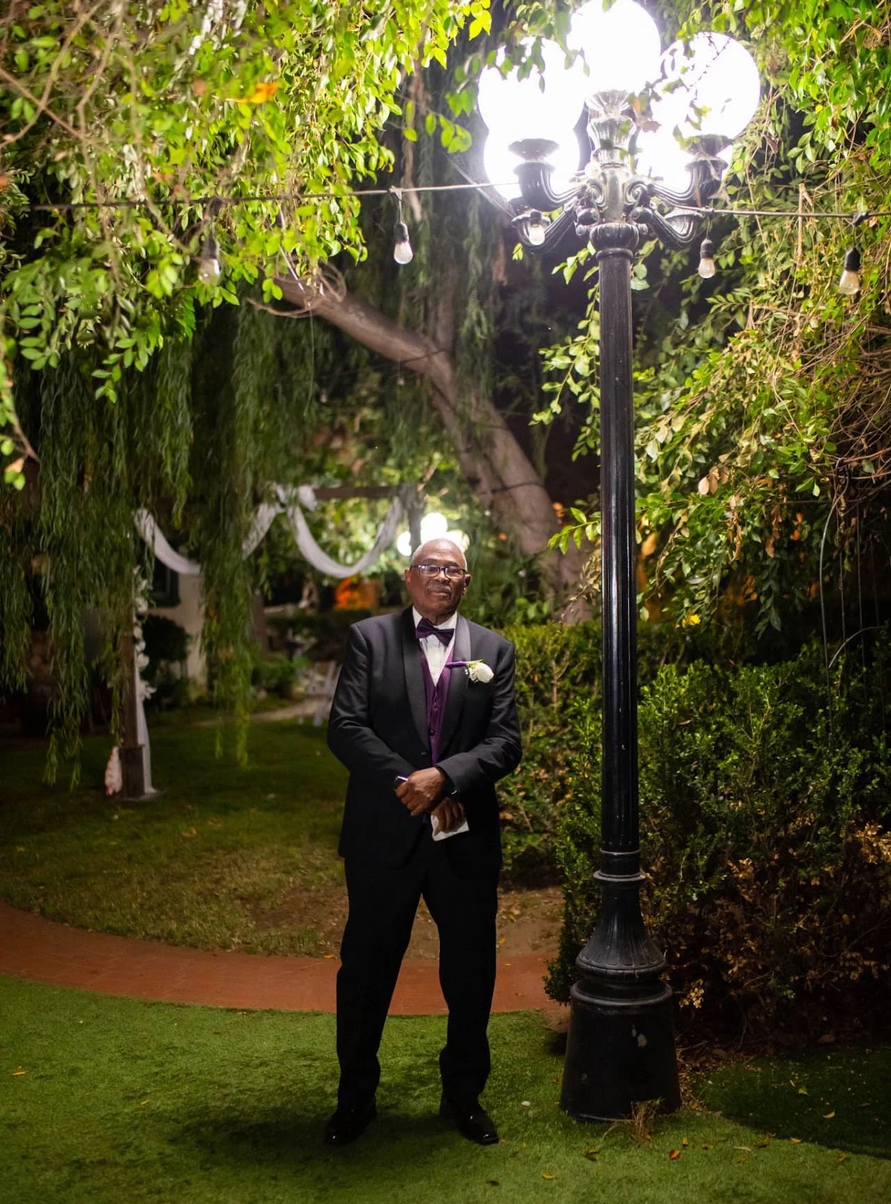 Formal portrait beside a garden lamp