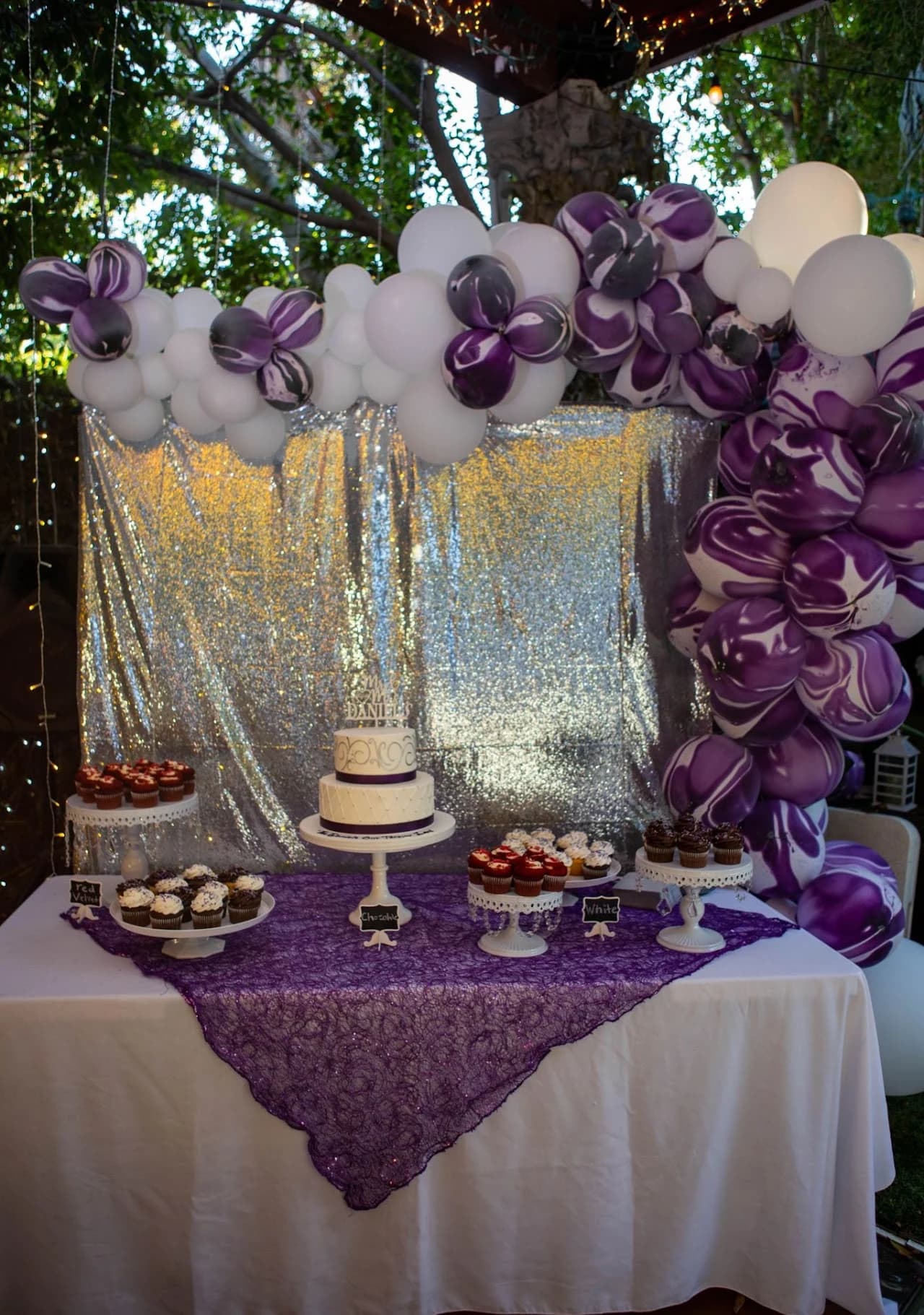 Cake display with purple floral accents