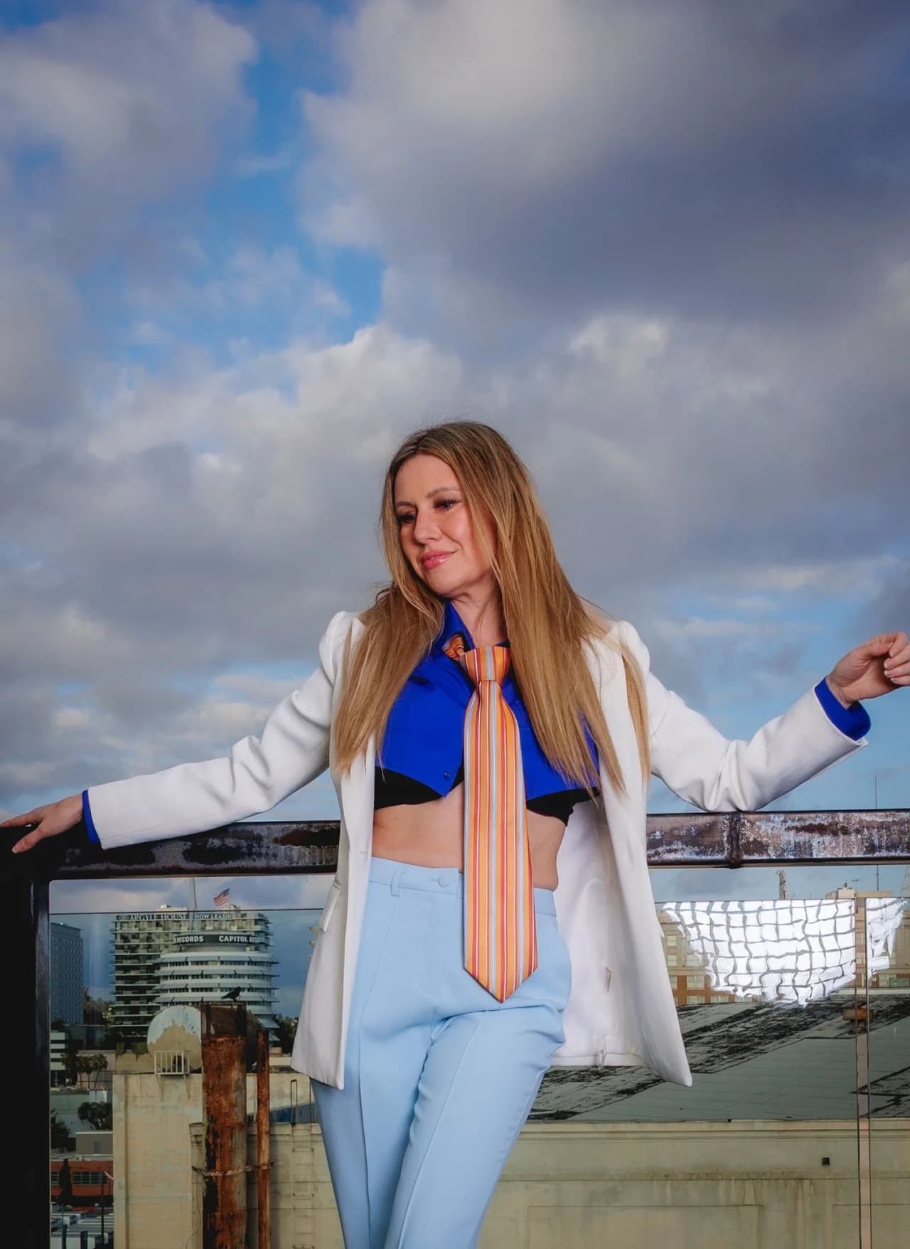 Light suit with blue and yellow styling against the sky